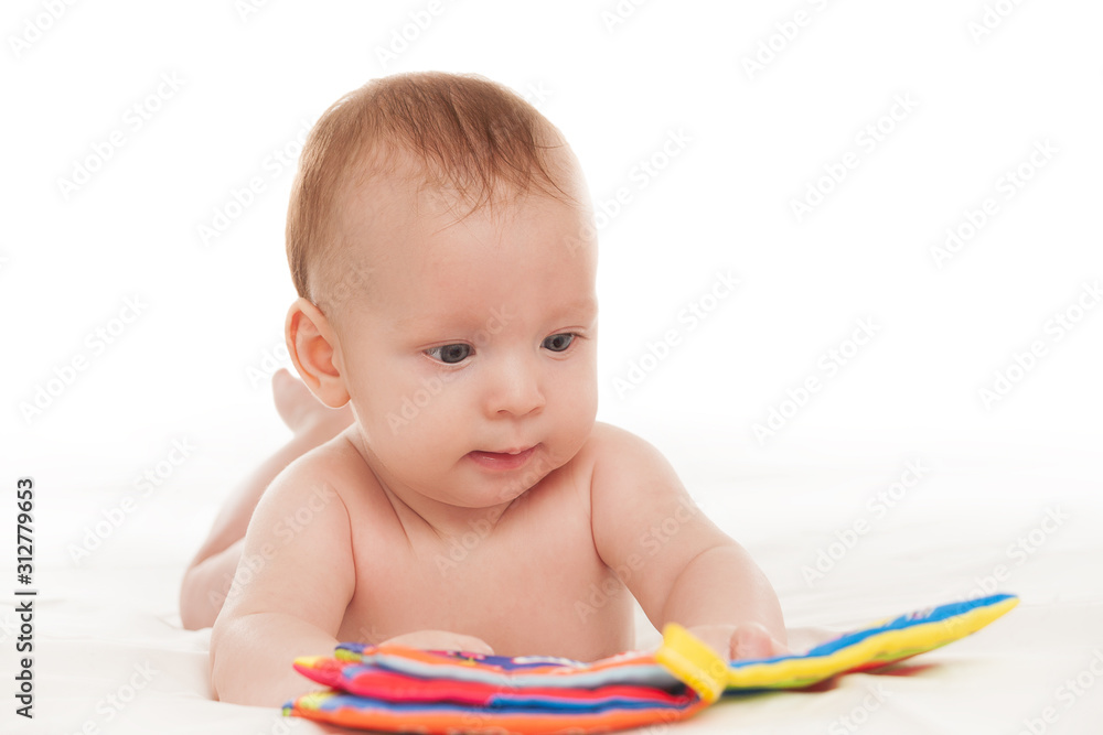 little happy motivated child is playing with dangling rattles, toys for newborn, first toy, isolated on white background, copy space, design little happy motivated child is playing with dangling rattles, toys for newborn, first toy, isolated on white background, copy space, design