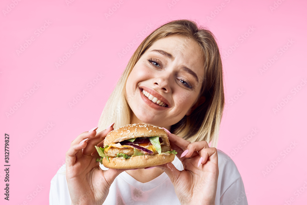 woman with hamburger and french fries woman with hamburger and french fries
