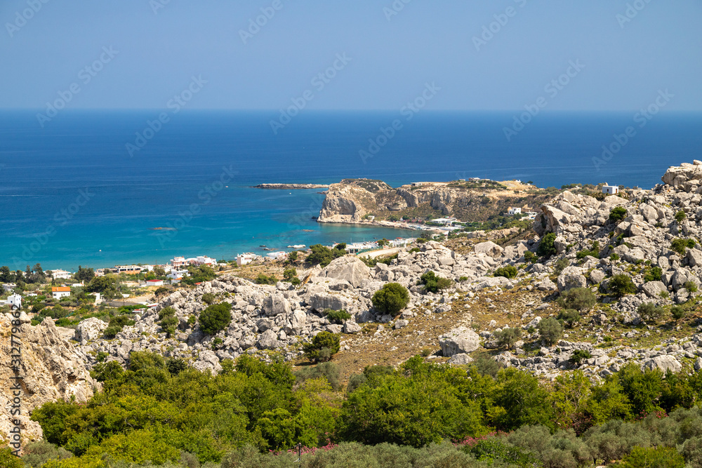 Fototapeta premium Scenic view at Stegna beach on Geek island Rhodes with rocks in the foreground and the mediterranean sea in the background