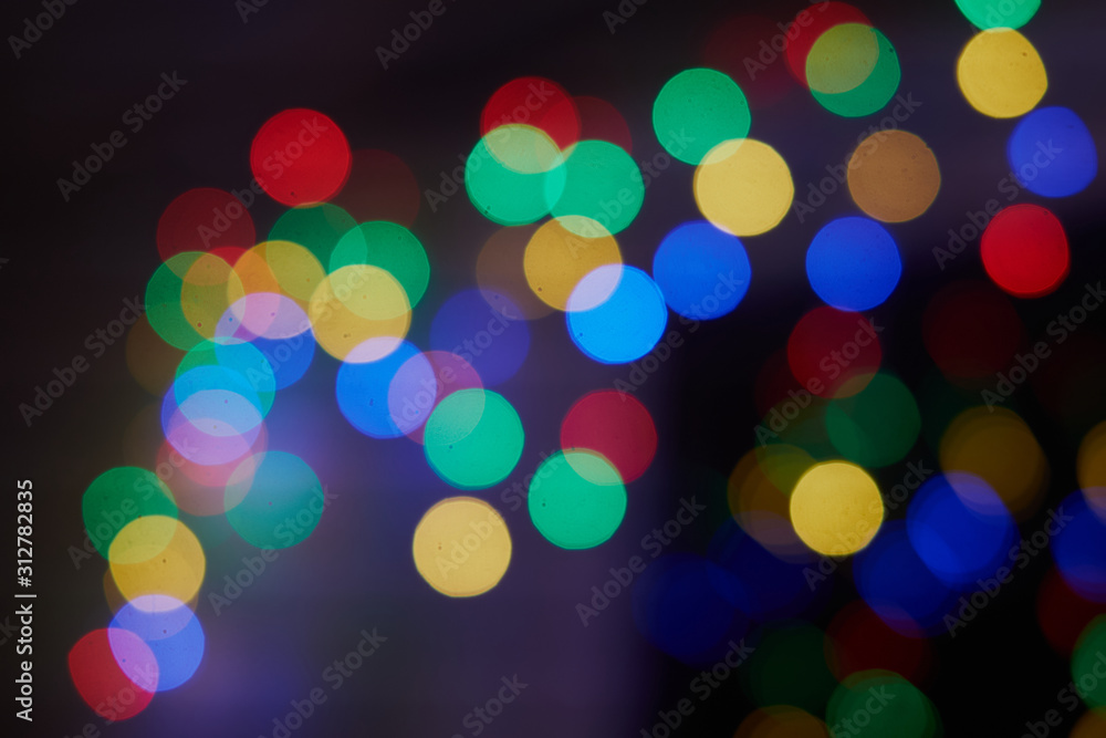 Obraz premium Various multicoloured bubles close up in dark light background, festival celebrities photo, bubbles,Christmas, New Year, Colorful bokeh. Bokeh, abstract light background.Holidays background.Festive