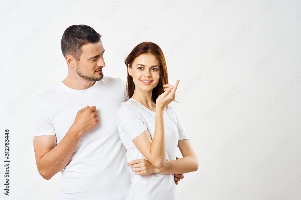 young couple in t-shirts chatting young couple in t-shirts chatting