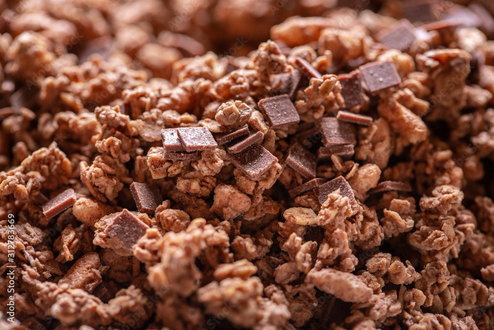 Obraz premium Muesli chocolate with pieces of chocolate and nuts