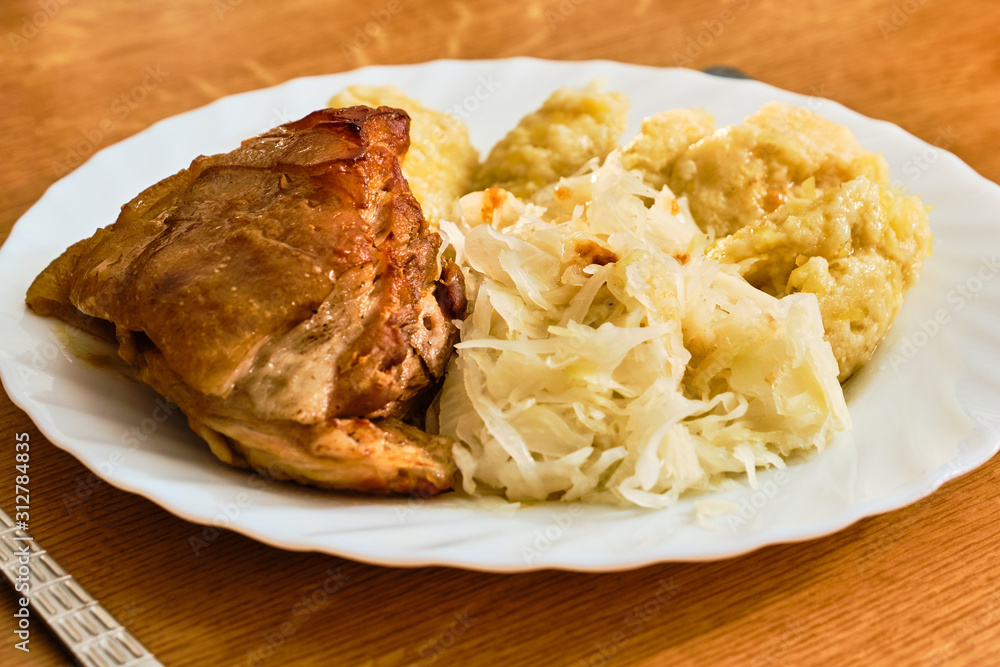 Roast pork knuckle with cabbage and dumplings