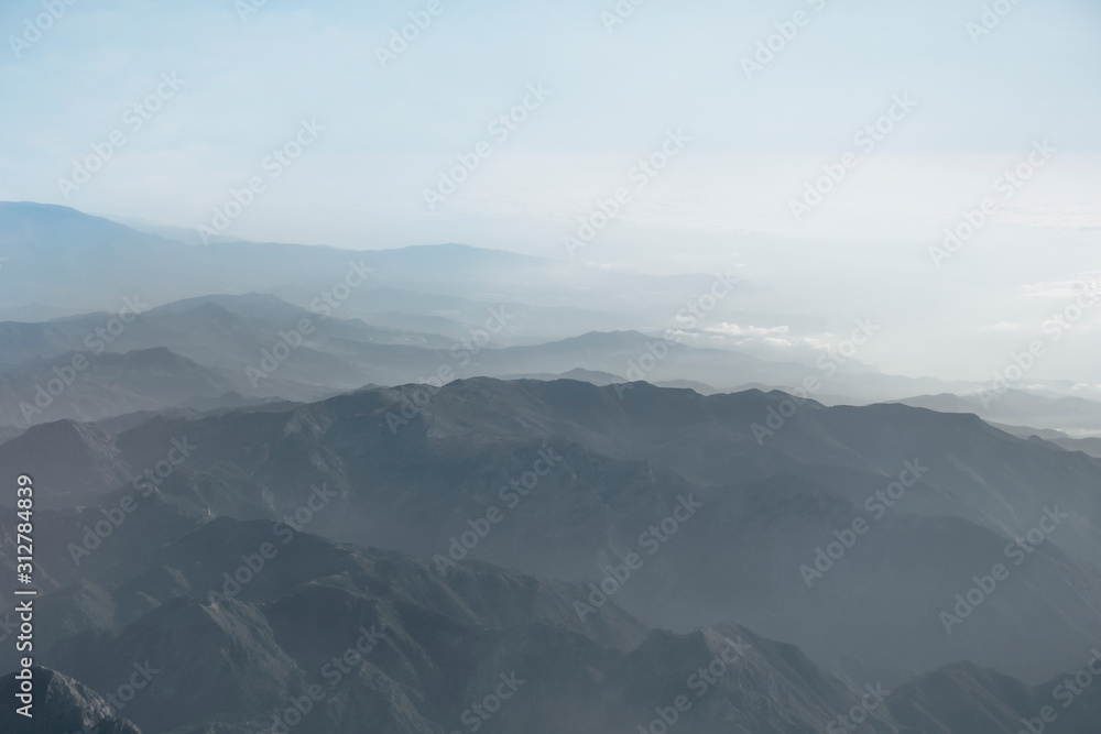 Beautiful mountain landscape in fog, seen from above