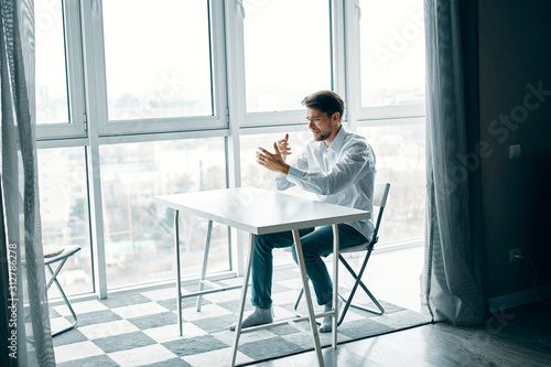 businessman sitting on chair and looking at camera