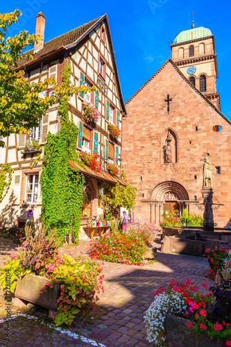 Beautiful church and traditional colorful houses in picturesque Kaysersberg village, Alsace wine region, France