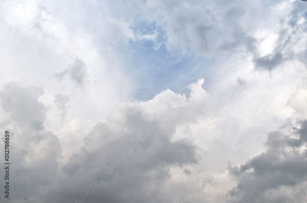 Blue sky and fluffy clouds. Beautiful cloudscape background. Sunlight on the clouds. Blue sky and fluffy clouds. Beautiful cloudscape background. Sunlight on the clouds.