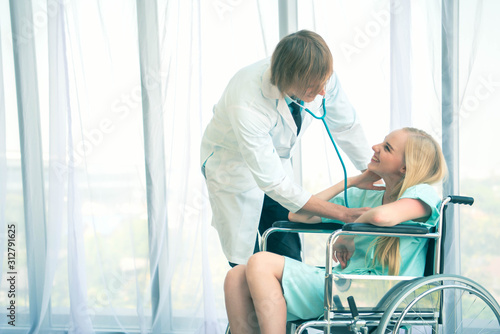 Doctor reassuring young woman in modern clinic