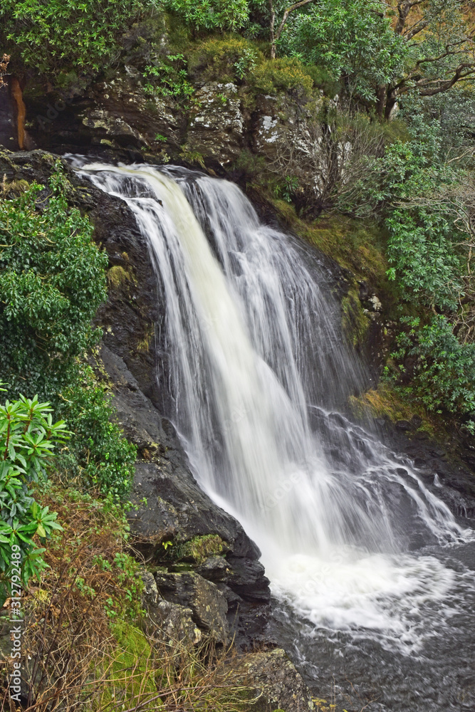 Fototapeta premium Waterfall at Inversnaid where the River Arklet flows into Loch Lomond. On the route of the West Highland Way, a famous long distance walking route in the Scottish Highlands.