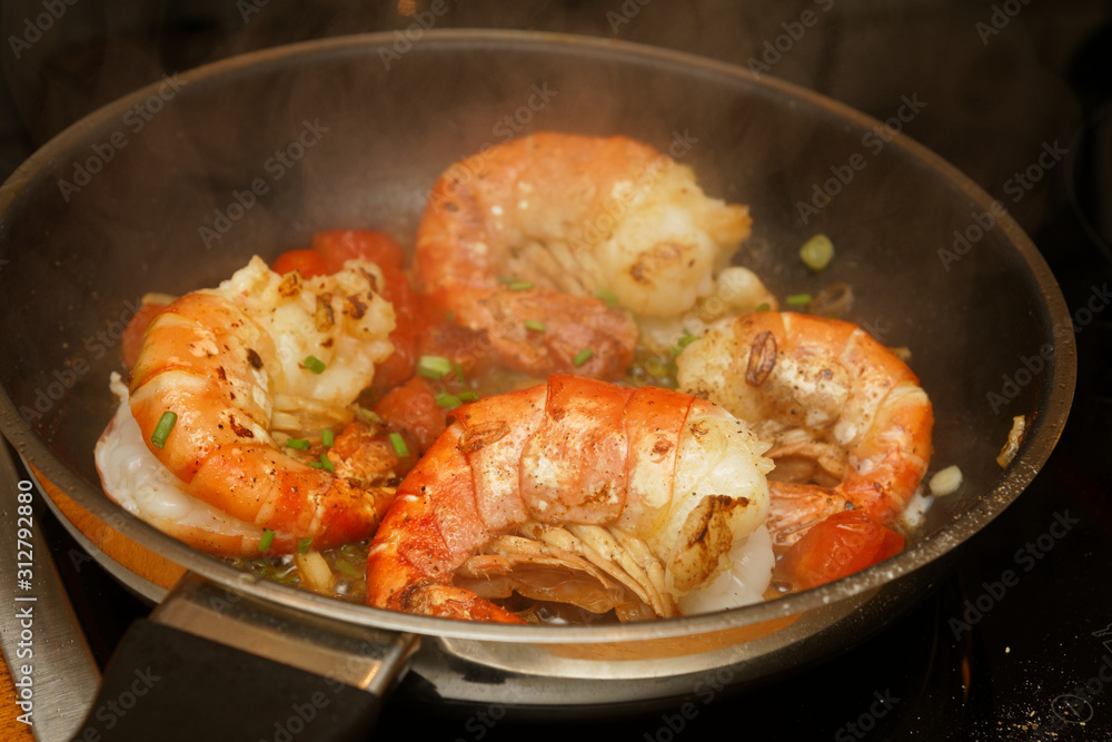 King prawns in a pan with tomatos and herbs King prawns in a pan with tomatos and herbs