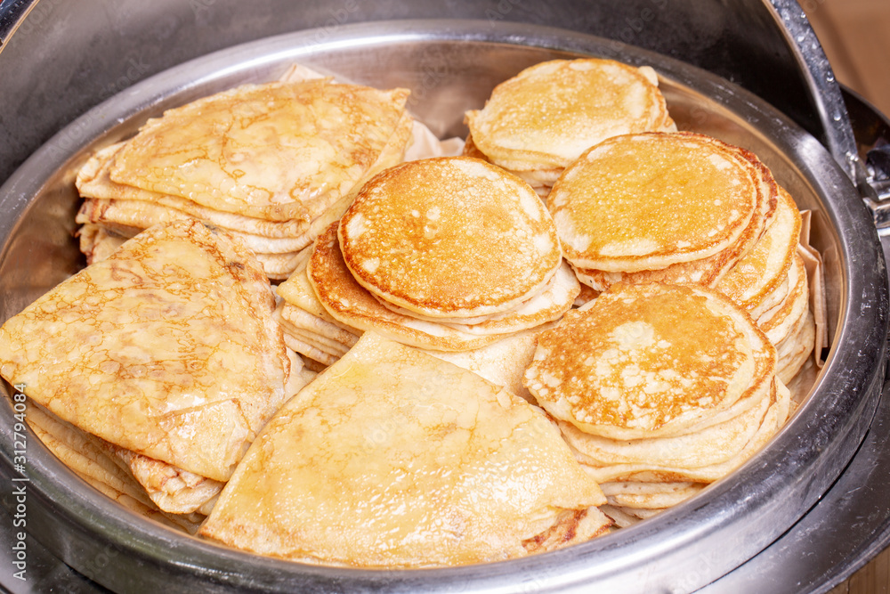 Pancakes and oladas in a heating room for breakfast Pancakes and oladas in a heating room for breakfast