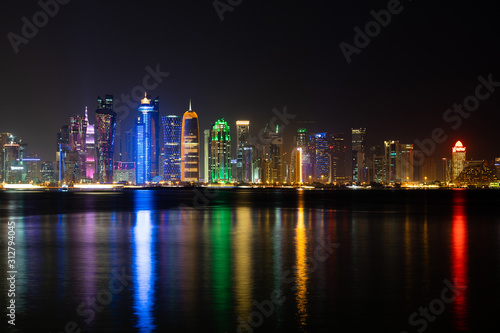 Wallpaper Mural Vibrant Skyline of Doha at Night as seen from the opposite side of the capital city bay at night Torontodigital.ca