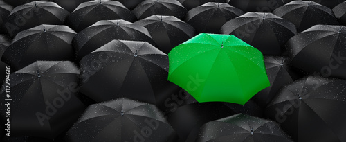 Leinwand Poster Green umbrella stand out from the crowd of many black umbrellas - being differen