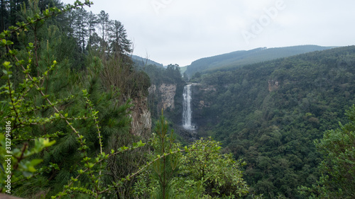 Karkloof Falls. Large Waterfall In a Lush Green Forest In Howick, South Africa. Surrounded By Mountain Cliffs, Trees and A Strong, Powerful Waterfall.