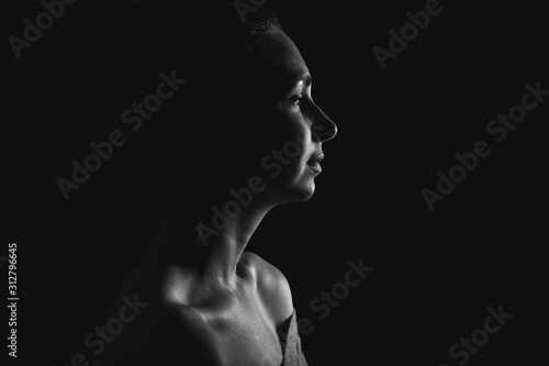 Silhouette of beautiful young woman on dark background