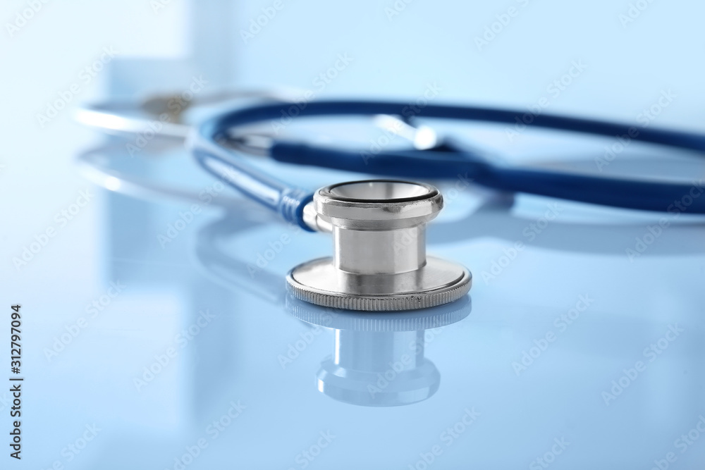 Modern stethoscope on white table, closeup Modern stethoscope on white table, closeup