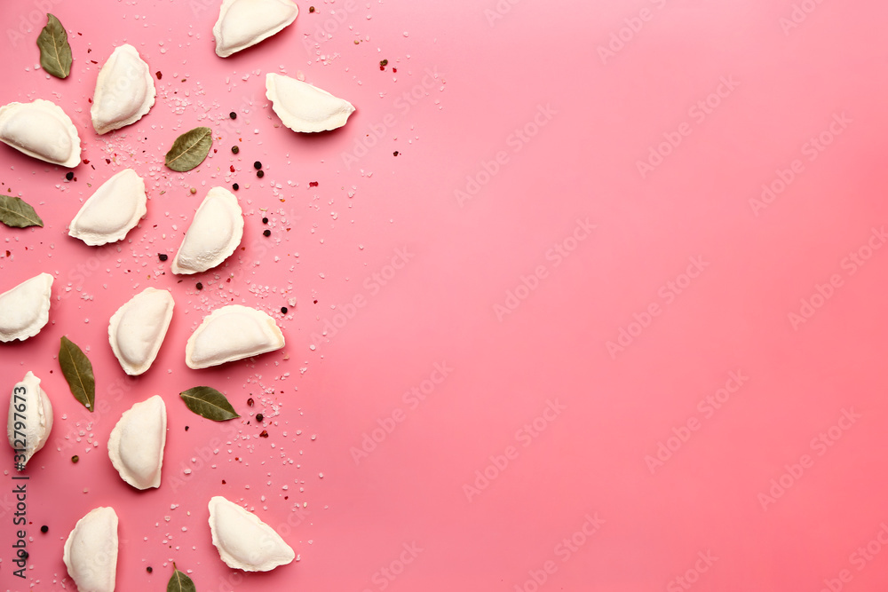 Raw dumplings with spices on color background Raw dumplings with spices on color background