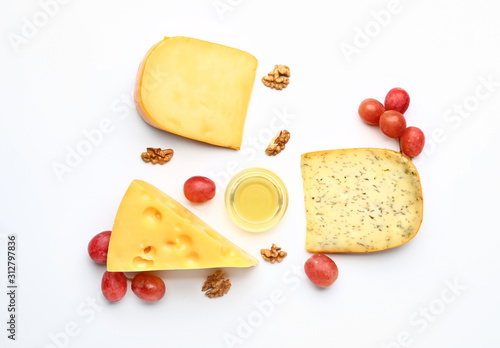 Assortment of fresh cheeses on white background