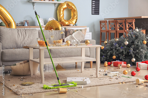 Cleaning of floor in room after New Year party photo