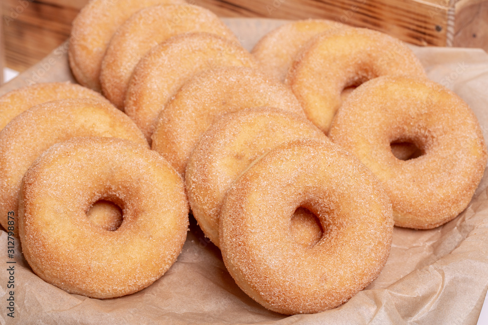 Doughnuts in sugar crumb on parchment Doughnuts in sugar crumb on parchment