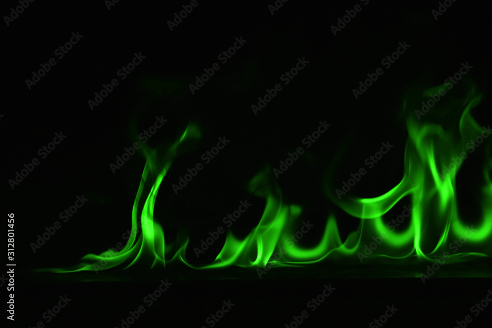 Beautiful fire green flames on a black background.