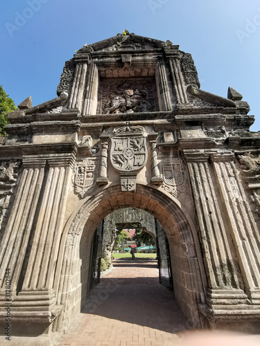 Fort Santiago Entrance Archway With Still Moat River In Front and Spanish Stone Carving Design in Intramuros, Manila, Philippines