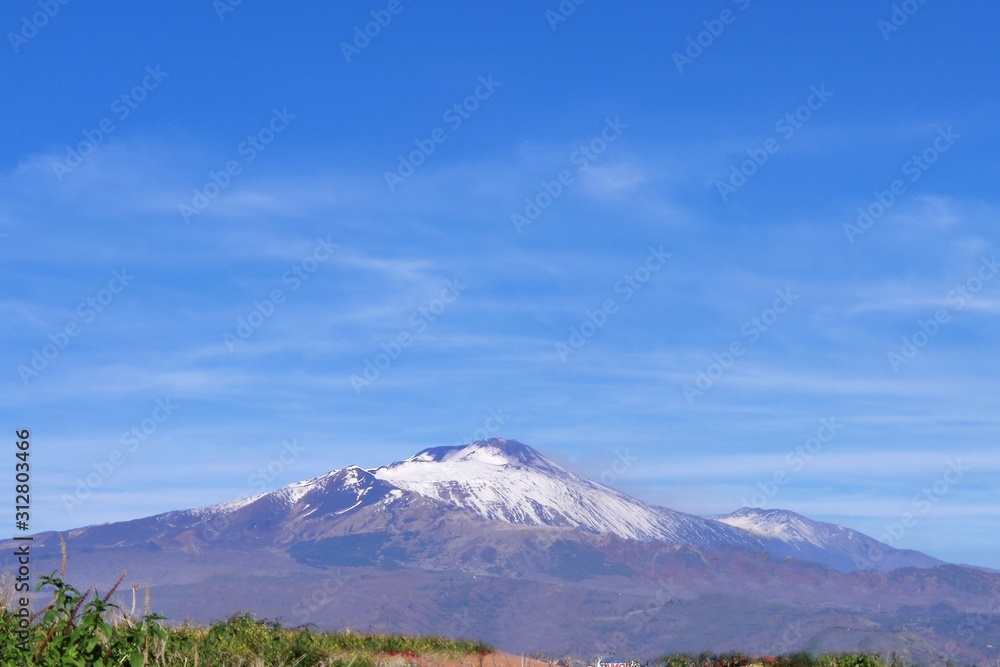 Etna volcano covered in snow. View from afar. Sicily