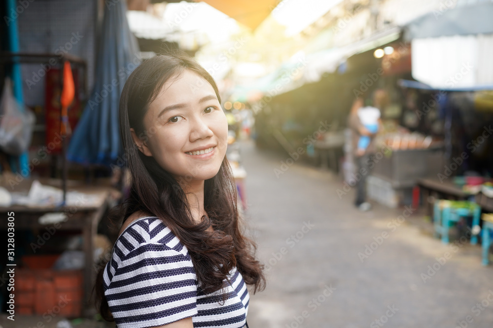 Asian woman walking around the traditional fresh market in Bangkok, Thailand close up with copy space.