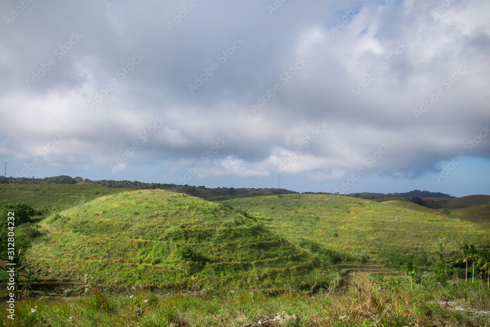 Rolling Teletubbies Hills With Lush Green Forests, Palm Trees and Rice Teraces on Nusa Penida, Bali, Indonesia Rolling Teletubbies Hills With Lush Green Forests, Palm Trees and Rice Teraces on Nusa Penida, Bali, Indonesia