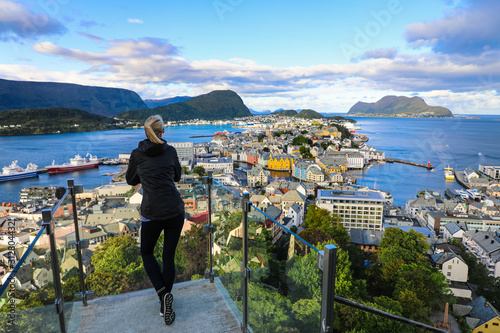 Fényképezés Blond woman enjoying aerial view of the colorful town of Alesund Norway