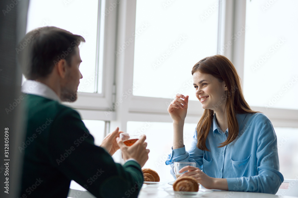 young couple having breakfast in the kitchen young couple having breakfast in the kitchen