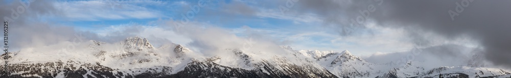 Whistler, British Columbia, Canada. Beautiful View of the Canadian Snow Covered Landscape with Blackcomb Mountain in Background during a cloudy and foggy winter day. Whistler, British Columbia, Canada. Beautiful View of the Canadian Snow Covered Landscape with Blackcomb Mountain in Background during a cloudy and foggy winter day.