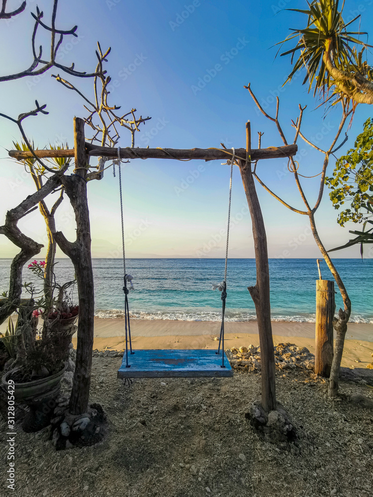 Beach Island Swing At Next Level Cafe Overlooking the Turquoise Ocean on Nusa Penida, Bali, Indonesia
