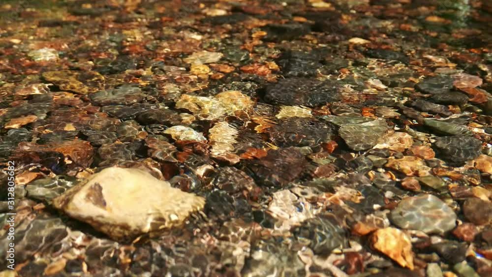 Static close up view of crystal clear tropical forest stream water with small pebbles can be clearly seen. Static close up view of crystal clear tropical forest stream water with small pebbles can be clearly seen.