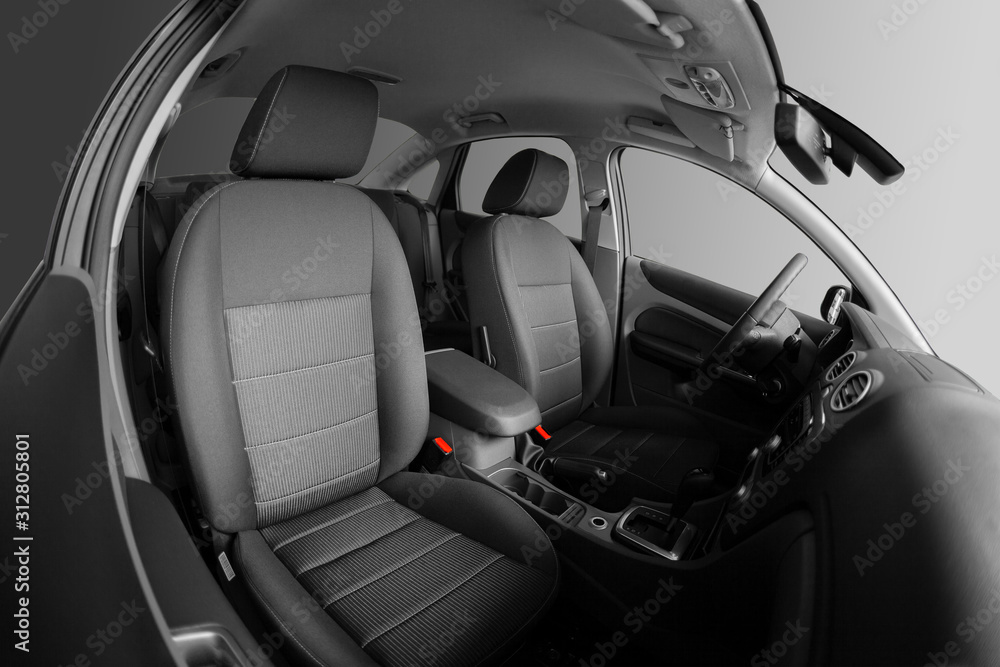 Interior of car. Car seats for driver and passenger. Steering wheel.