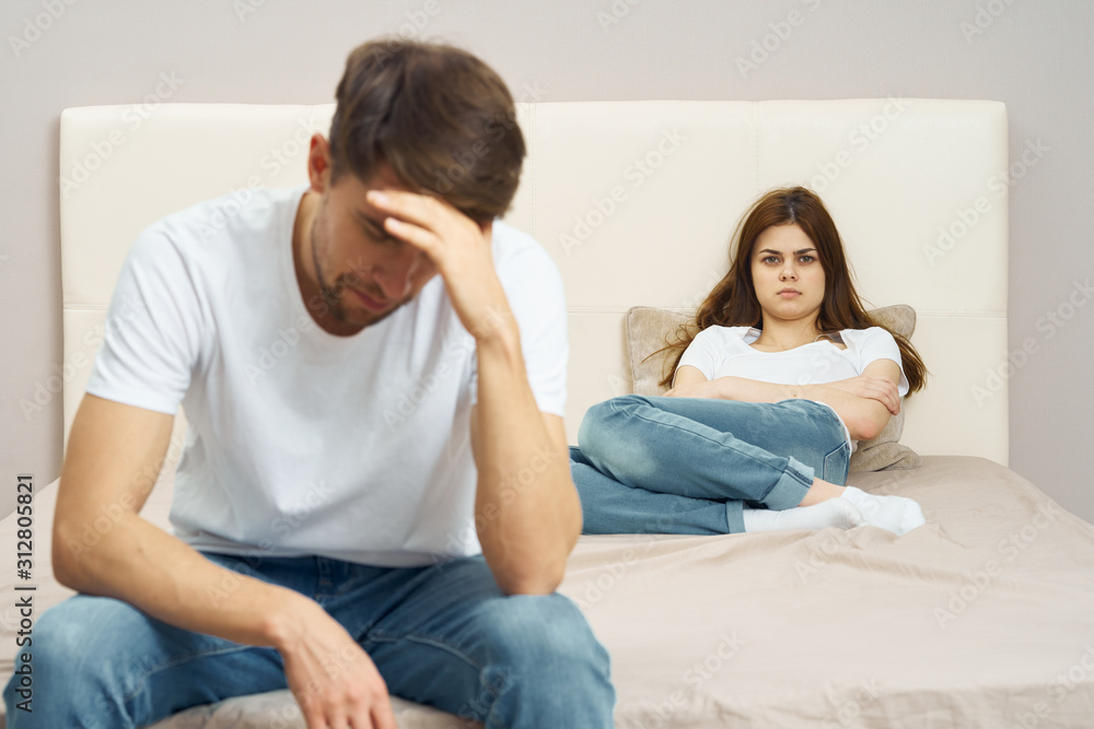 young couple sitting on sofa and watching tv young couple sitting on sofa and watching tv