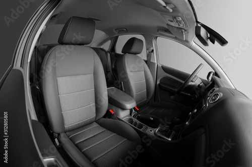 Interior of car. Car seats for driver and passenger. Steering wheel.