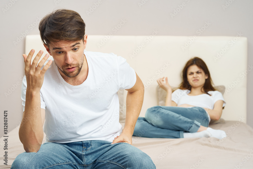 couple sitting on sofa and watching tv couple sitting on sofa and watching tv