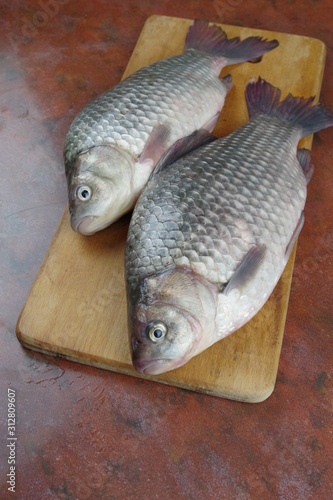 crucian fish lying on the table top view