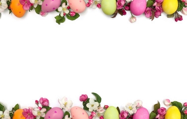 Easter decoration. Easter frame of pink flowers apple tree and colored easter eggs on white background with space for text. Top view, flat lay