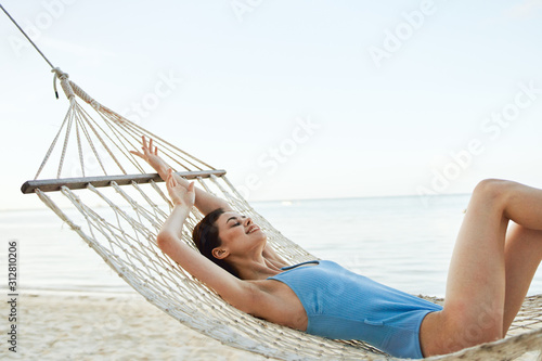 woman lying on hammock on the beach © SHOTPRIME STUDIO