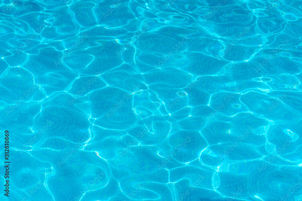 Water surface with light reflections in a swimming pool as a background Water surface with light reflections in a swimming pool as a background