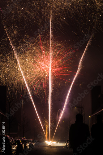 People celebrating New Year party on the streets of Netherlands, setting fireworks and flame races, setting on fire
