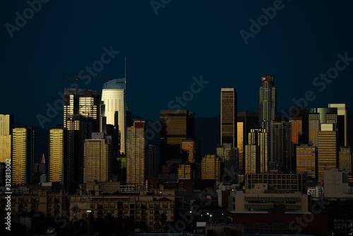 Night shot of Los Angeles downtown with its highrises reflecting the light