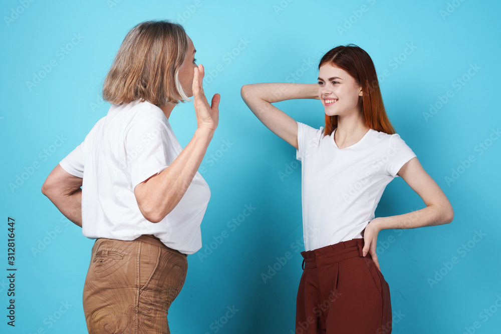 Grandmother and granddaughter are standing nearby Grandmother and granddaughter are standing nearby