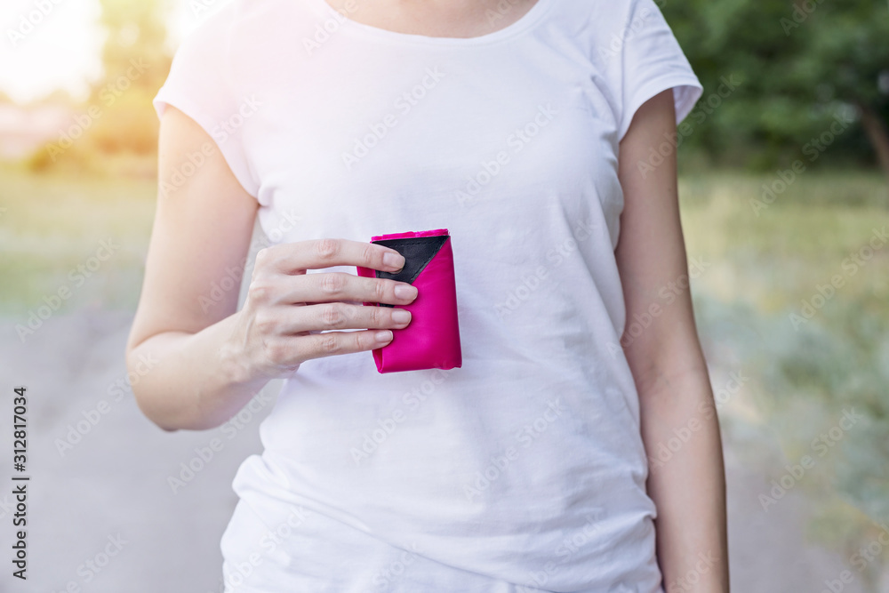 Woman with pink folded drawstring bag on her hand. Woman with pink folded drawstring bag on her hand.