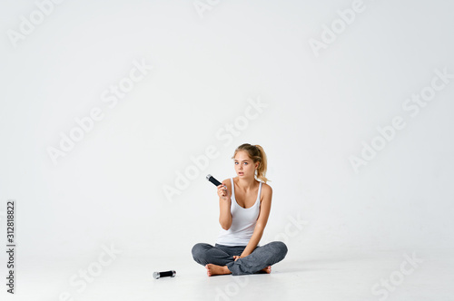 woman sitting on the floor and talking on mobile phone
