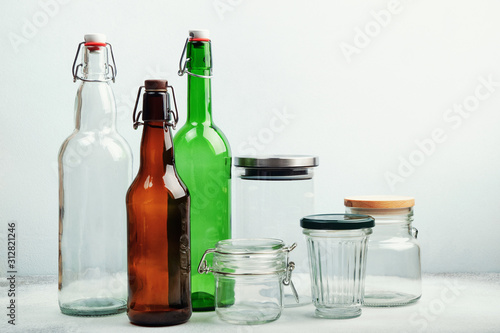 Reusable glass bottles and jars on table. Sustainable lifestyle. Zero waste grocery shopping and storage concept