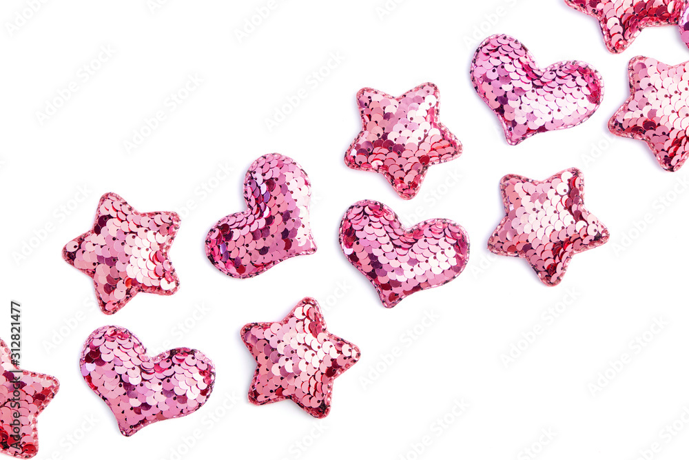 Valentine's day decorative bakground. Pink sequin hearts and stars on white Valentine's day decorative bakground. Pink sequin hearts and stars on white