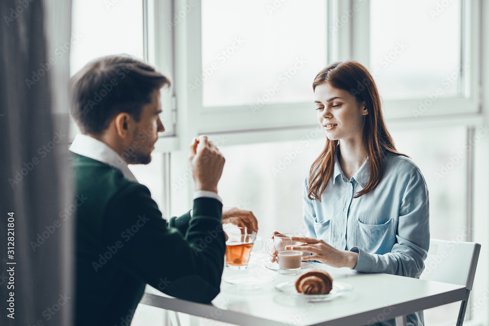 young couple having breakfast in the kitchen young couple having breakfast in the kitchen